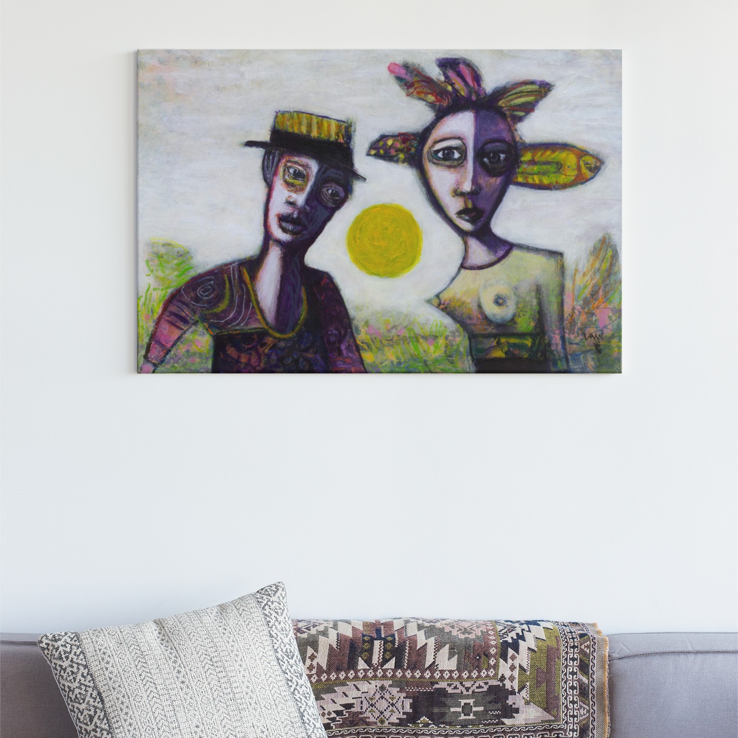 Sofa with decorative pillows and a blanket, featuring a colorful painting of two figures on the wall above.