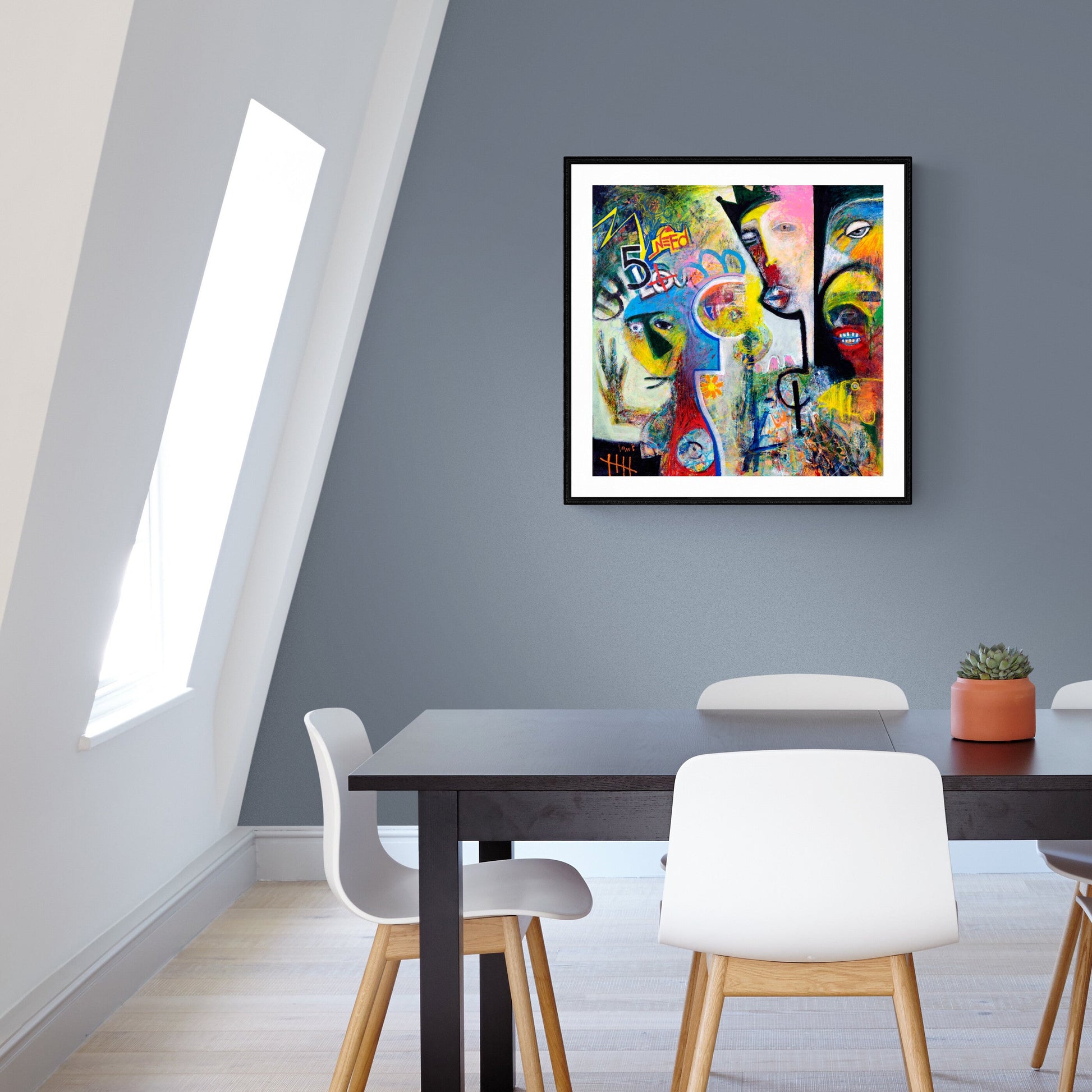 Dining room with a colorful abstract painting of street art on the wall