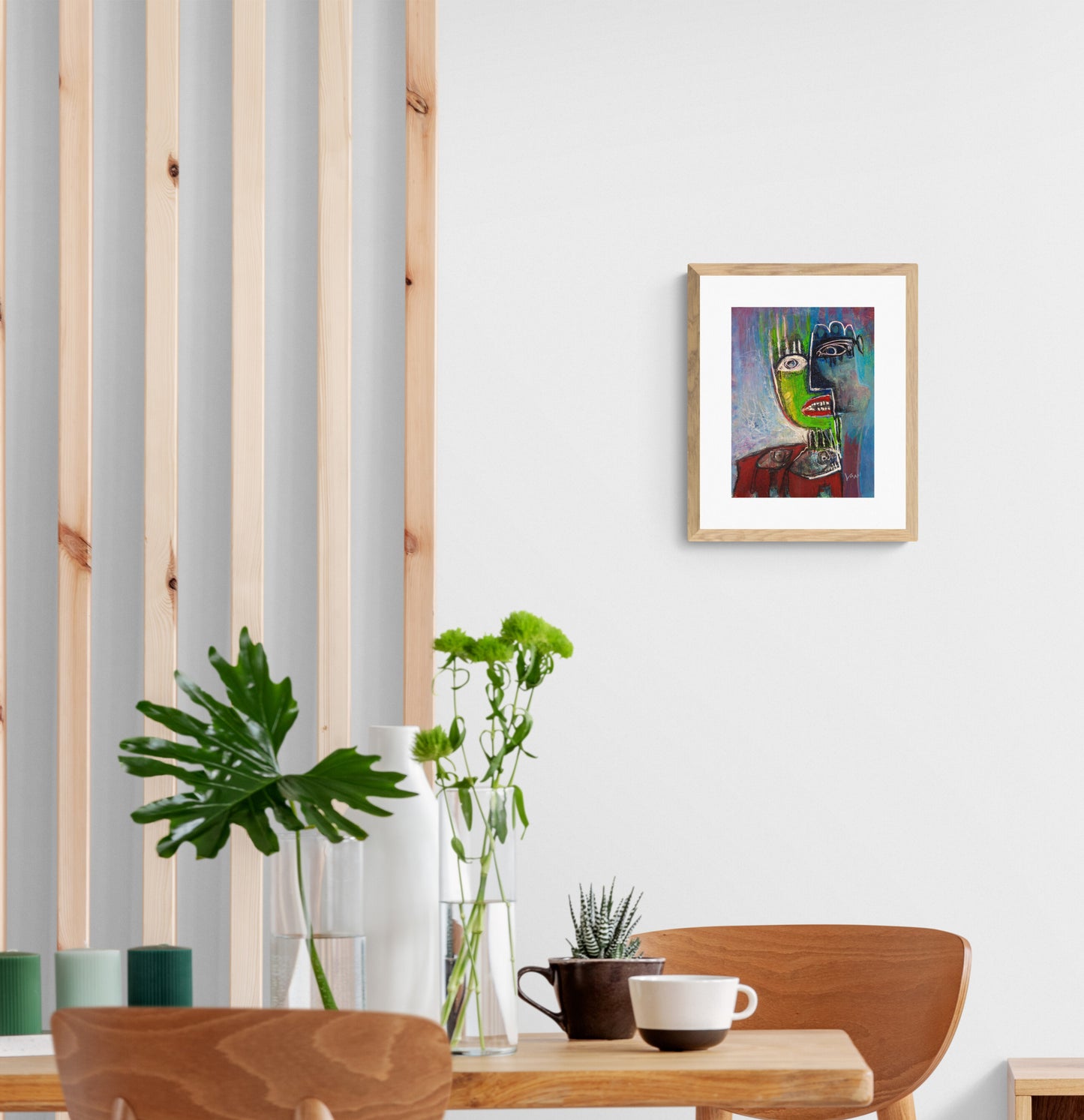 Dining room with wooden table, chairs, and a colorful framed picture on the wall.