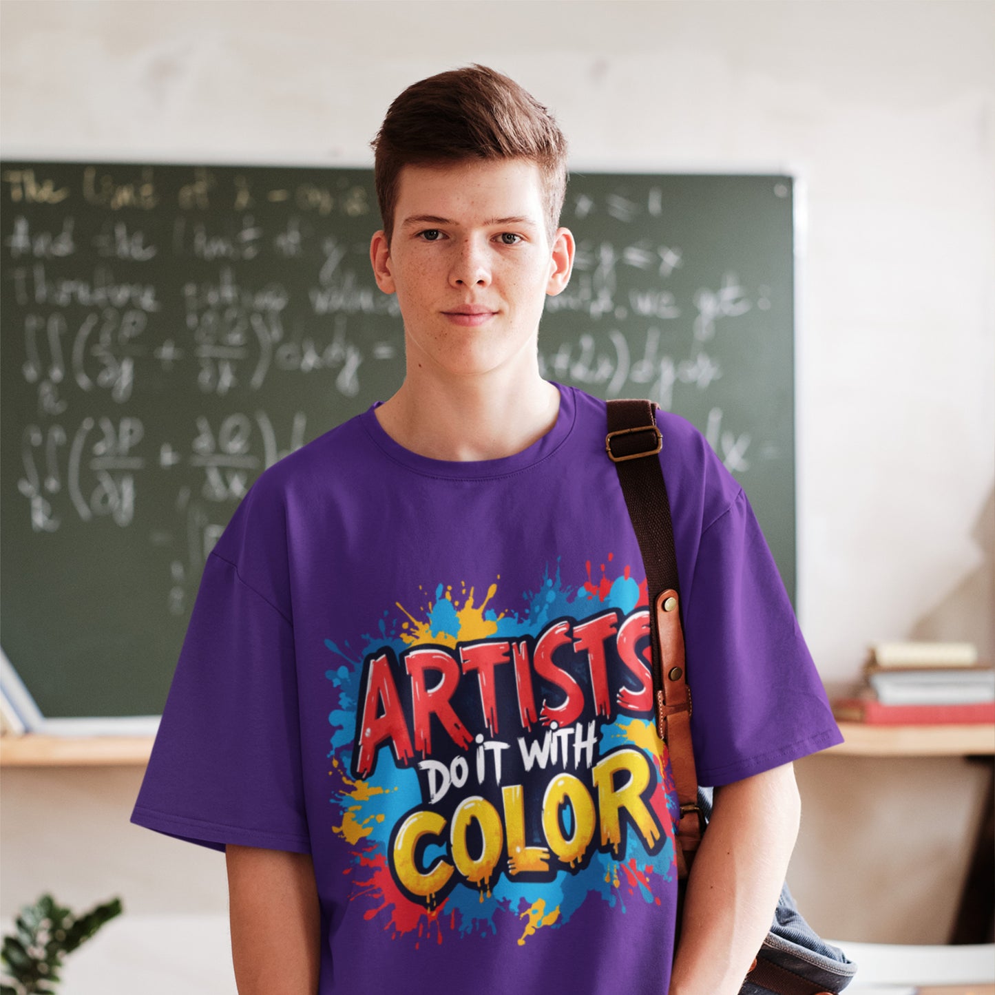 Person wearing a purple t-shirt with colorful text in a classroom setting