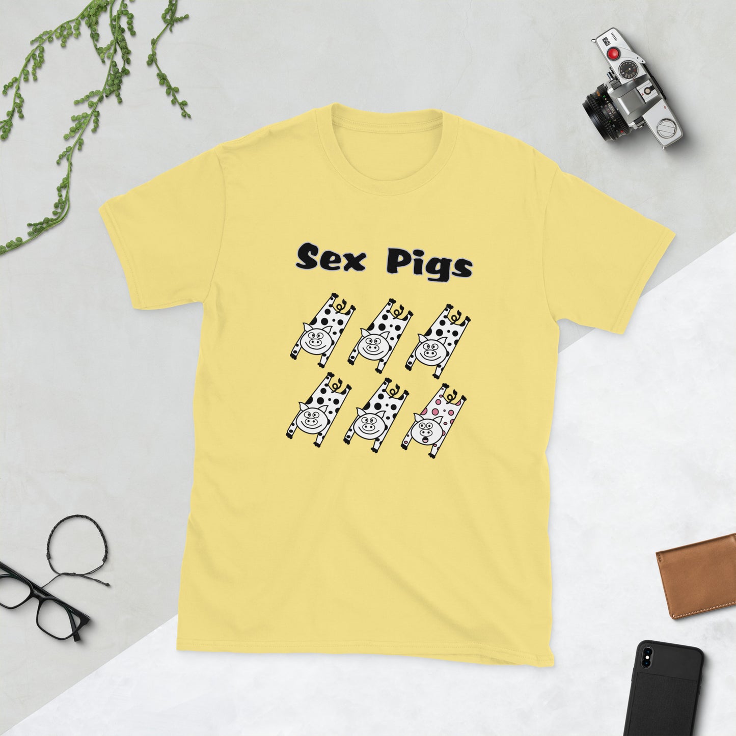 Yellow t-shirt with 'Sex Pigs' graphic on a light gray background