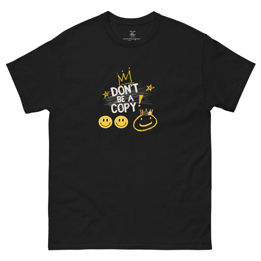 A black short-sleeve crewneck t-shirt with a graphic on the chest that reads 'DON'T BE A COPY!' in white and yellow, accompanied by yellow smiley faces and a crown illustration, shown on a plain white background.
