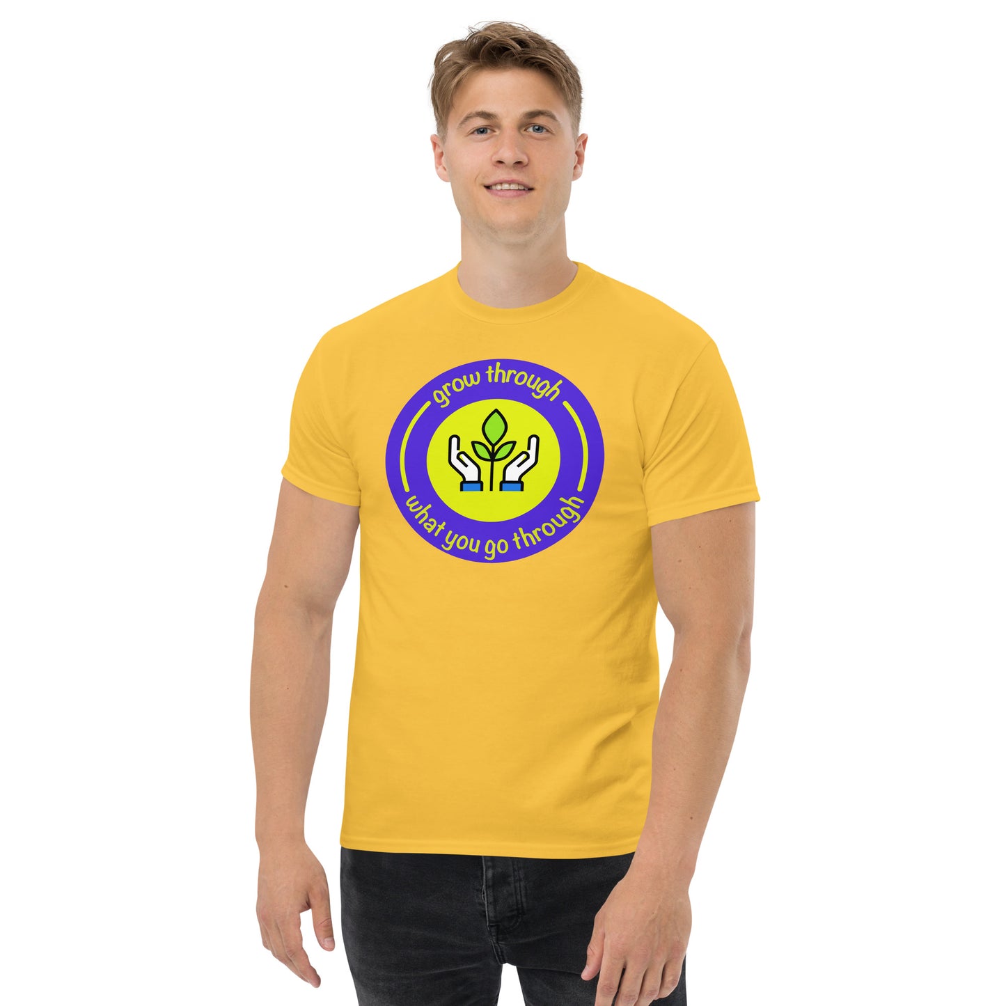 Person wearing a yellow t-shirt with a circular design and text on a white background