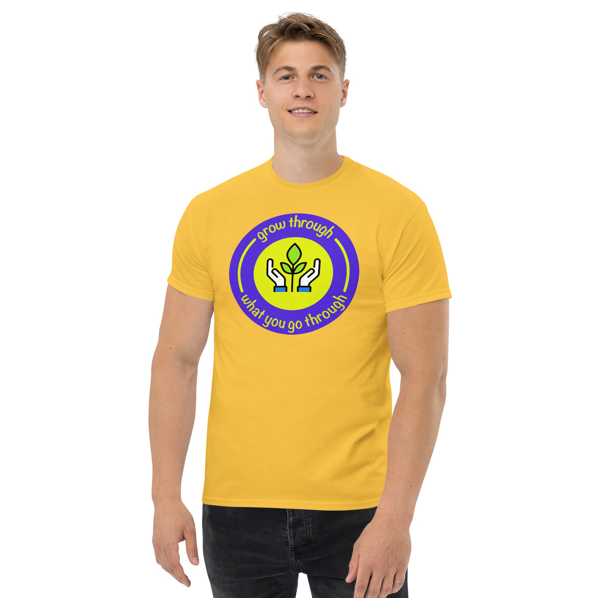 Person wearing a yellow t-shirt with a circular design and text on a white background