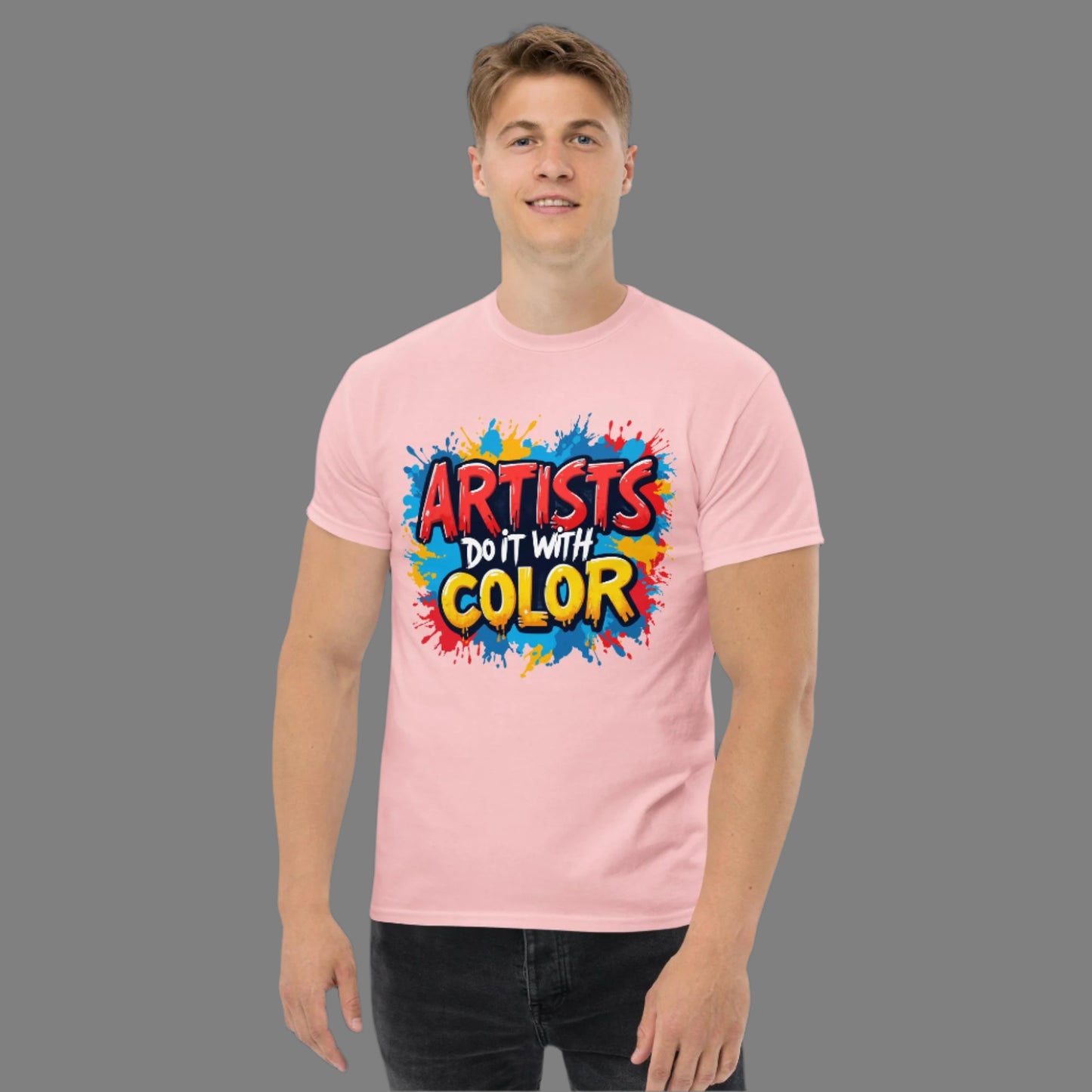 Person wearing a pink t-shirt with 'Artists Do It With Color' text and colorful design.