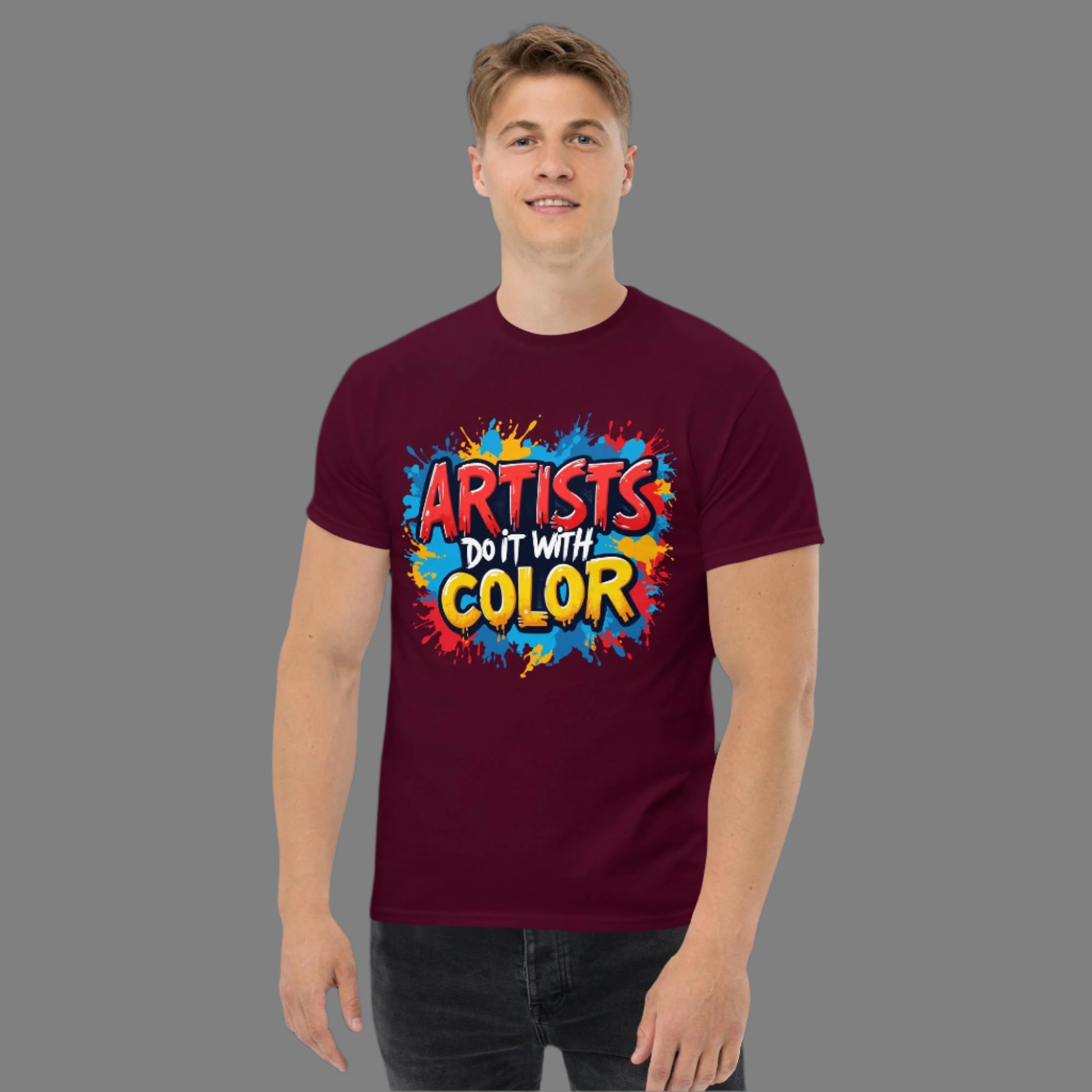 Person wearing a maroon t-shirt with colorful text design on a black background