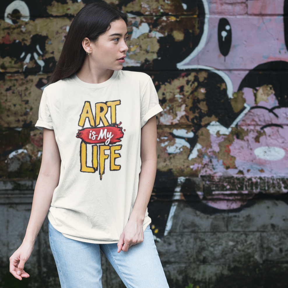 Person wearing a 'Art is my Life' t-shirt standing in front of graffiti.