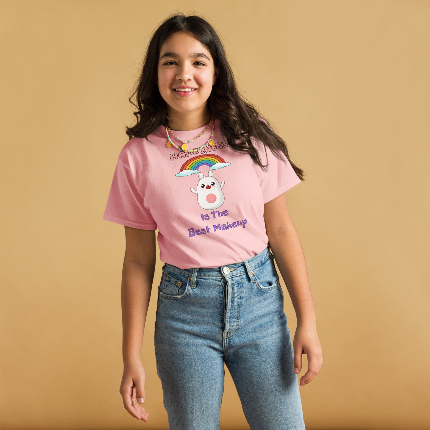 Person wearing a pink t-shirt with a graphic design on a beige background